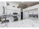 Well-lit kitchen with white cabinets, stainless steel appliances, and a sleek marble-patterned island at 756 E Appaloosa Rd, Gilbert, AZ 85296