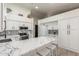Well-appointed kitchen with white cabinets, stainless steel appliances, marble countertops, and a charming decorative backsplash at 756 E Appaloosa Rd, Gilbert, AZ 85296