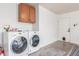 This laundry room is equipped with a washer and dryer and cabinetry at 756 E Appaloosa Rd, Gilbert, AZ 85296