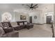 Open living area with a large sectional sofa, neutral rug, and tiled floors, offering a cozy gathering space at 756 E Appaloosa Rd, Gilbert, AZ 85296