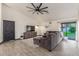 Spacious living room with vaulted ceilings, stylish decor, and sliding glass doors to yard at 756 E Appaloosa Rd, Gilbert, AZ 85296