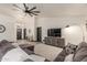 Bright living room featuring a modern ceiling fan, hard floors, a large sectional, and stylish decor at 756 E Appaloosa Rd, Gilbert, AZ 85296