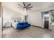 Spacious main bedroom featuring decorative headboard, blue settee and ample natural light at 756 E Appaloosa Rd, Gilbert, AZ 85296