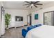 Bright main bedroom with a plush blue settee, neutral decor, and a large television at 756 E Appaloosa Rd, Gilbert, AZ 85296
