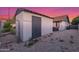 A storage shed is on the side of this home in a gravel-covered area at 756 E Appaloosa Rd, Gilbert, AZ 85296