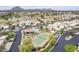 Scenic aerial view featuring a community, tennis court, pool, and mountain views at 8100 E Camelback Rd # 143, Scottsdale, AZ 85251