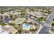 Aerial view of a community showcasing a pool, tennis court, and residential buildings at 8100 E Camelback Rd # 143, Scottsdale, AZ 85251