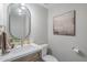 Well-lit half bath featuring a stylish vanity with brushed gold fixtures and modern decor at 8100 E Camelback Rd # 143, Scottsdale, AZ 85251