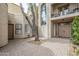 Inviting courtyard with brick pavers leading to the front door and a second story balcony at 8100 E Camelback Rd # 143, Scottsdale, AZ 85251