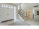 Bright entryway with staircase and view of a doorway, tiled flooring and a light-colored rug at 8100 E Camelback Rd # 143, Scottsdale, AZ 85251