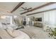 Open concept living room featuring white sofa and tile flooring connecting to the dining room at 8100 E Camelback Rd # 143, Scottsdale, AZ 85251