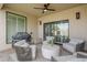 Covered patio with comfortable seating, a ceiling fan, and a grill at 8100 E Camelback Rd # 143, Scottsdale, AZ 85251