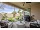 Inviting patio with outdoor seating, a grill, and serene views of the well-maintained backyard at 8100 E Camelback Rd # 143, Scottsdale, AZ 85251