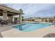 Community pool featuring a spacious deck, shaded seating, and mature landscaping at 8100 E Camelback Rd # 143, Scottsdale, AZ 85251