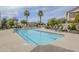 Community pool with lounge chairs and sunny skies and landscaping at 8100 E Camelback Rd # 143, Scottsdale, AZ 85251