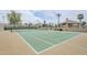 Aerial view of a well-maintained tennis court surrounded by lush landscaping at 8100 E Camelback Rd # 143, Scottsdale, AZ 85251