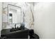 Elegant powder room featuring marble tile, a black countertop, and a contemporary sink at 8147 E Redberry --, Mesa, AZ 85207