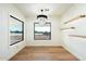 Minimalist dining room with hardwood floors, chandelier and exterior view at 8147 E Redberry --, Mesa, AZ 85207