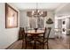 Charming dining room with wood table, chandelier, and view of laundry area at 9735 N 94Th Pl # 110, Scottsdale, AZ 85258