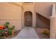 Welcoming entrance to the unit, decorated with desert plants and a secure screen door at 9735 N 94Th Pl # 110, Scottsdale, AZ 85258