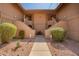 Inviting condo exterior with well-maintained landscaping and dual staircase access at 9735 N 94Th Pl # 110, Scottsdale, AZ 85258