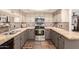 Well-lit kitchen featuring stainless steel appliances, stylish backsplash, and neutral-toned cabinetry at 9735 N 94Th Pl # 110, Scottsdale, AZ 85258