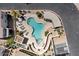Aerial view showcasing a community pool, lounge chairs, an outdoor eating area, lush desert landscaping and accessible parking at 9750 N Monterey Dr # 50, Fountain Hills, AZ 85268