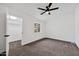 This bedroom features neutral walls, carpeted floor, a ceiling fan, and a window with a view at 10631 N 15Th Way # 4, Phoenix, AZ 85020