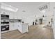 Open-concept kitchen with breakfast bar, updated appliances, and view of the living space at 10631 N 15Th Way # 4, Phoenix, AZ 85020