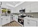 Modern kitchen with stainless steel appliances, white cabinets, and gray subway tile backsplash at 10631 N 15Th Way # 4, Phoenix, AZ 85020