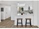 Eat-in kitchen with stools at the breakfast bar, white cabinets and modern appliances at 10631 N 15Th Way # 4, Phoenix, AZ 85020