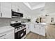 Bright kitchen with white cabinets, breakfast bar, and an open floor plan at 10631 N 15Th Way # 4, Phoenix, AZ 85020