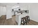 Bright kitchen features white cabinets, stainless appliances, and a marble waterfall island with seating at 10631 N 15Th Way # 4, Phoenix, AZ 85020