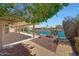 Beautiful backyard overlooking the water with lush landscaping and a spacious covered patio at 10913 W Chino Dr, Peoria, AZ 85373