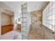 Tiled shower with built-in bench seating and glass block partition, adjacent to a vanity area at 10913 W Chino Dr, Peoria, AZ 85373