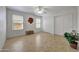 Bright bedroom with tile floors, ceiling fan, and sliding closet doors for ample storage at 10913 W Chino Dr, Peoria, AZ 85373