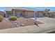 Attractive home exterior featuring a well-maintained yard, desert landscaping, and a two-car garage at 10913 W Chino Dr, Peoria, AZ 85373