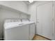 Bright laundry room featuring a white washer and dryer and a shelf for storage at 10913 W Chino Dr, Peoria, AZ 85373