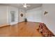 Large living room with hardwood floors, neutral walls, ceiling fan and access to bathroom at 10913 W Chino Dr, Peoria, AZ 85373