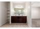 Bathroom featuring a double sink vanity with dark wood cabinetry and large mirror at 1146 E Viola Ct, Casa Grande, AZ 85122