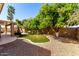 The backyard features mature trees with manicured lawn and rock landscaping at 1182 E Harrison St, Gilbert, AZ 85295