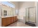 Spacious bathroom featuring double sinks, glass enclosed shower, soaking tub and large mirror at 1182 E Harrison St, Gilbert, AZ 85295