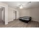 Bright bedroom with light-colored floors, ceiling fan and walk-in closet for optimal storage at 1182 E Harrison St, Gilbert, AZ 85295