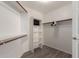 Walk-in closet with built-in shelving and hanging rods, providing ample storage space at 1182 E Harrison St, Gilbert, AZ 85295