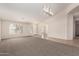 Bright living room showcasing vaulted ceilings, neutral carpet, and an abundance of natural light at 1182 E Harrison St, Gilbert, AZ 85295