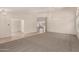 Spacious living room with neutral carpeting, arched doorways, and modern lighting fixtures at 1182 E Harrison St, Gilbert, AZ 85295