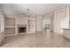 Inviting living room with a cozy fireplace, built-in shelving, and tile flooring throughout at 1182 E Harrison St, Gilbert, AZ 85295