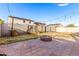 Private backyard featuring a brick firepit and low-maintenance landscaping at 12056 W Melinda Ln, Sun City, AZ 85373
