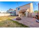 Spacious backyard offering a brick firepit, low-maintenance landscaping, and perimeter block fencing at 12056 W Melinda Ln, Sun City, AZ 85373