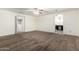 Large carpeted bedroom with ceiling fan and doorways to a bathroom and another room at 12056 W Melinda Ln, Sun City, AZ 85373